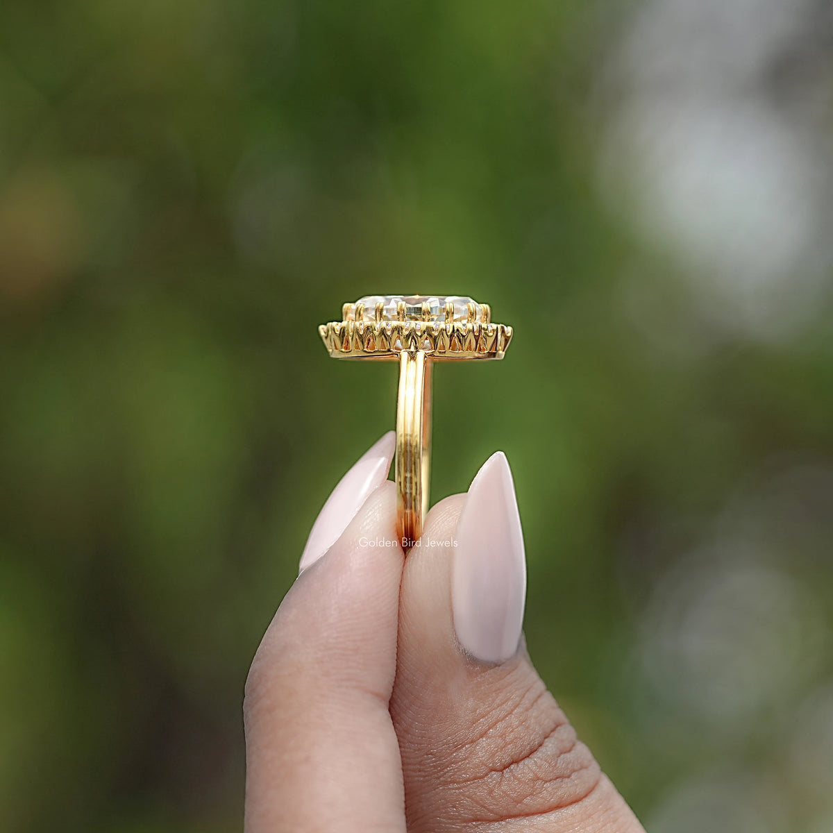 Gold-tone ring setting top view with prong-set halo stones