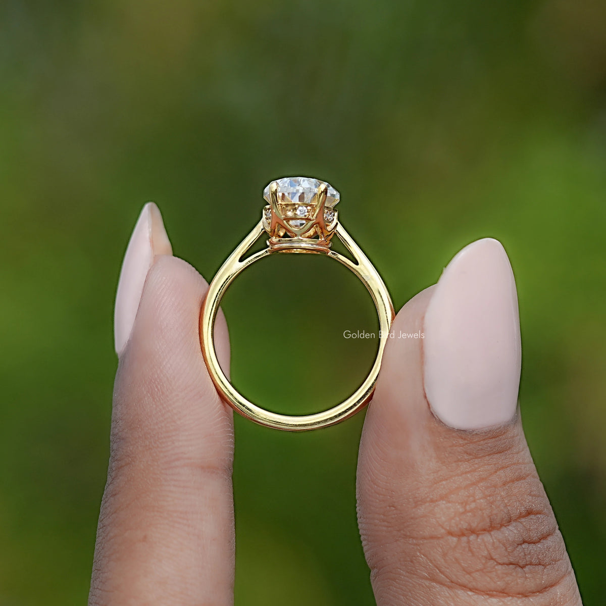 Gold band oval moissanite ring with hidden halo, underside view