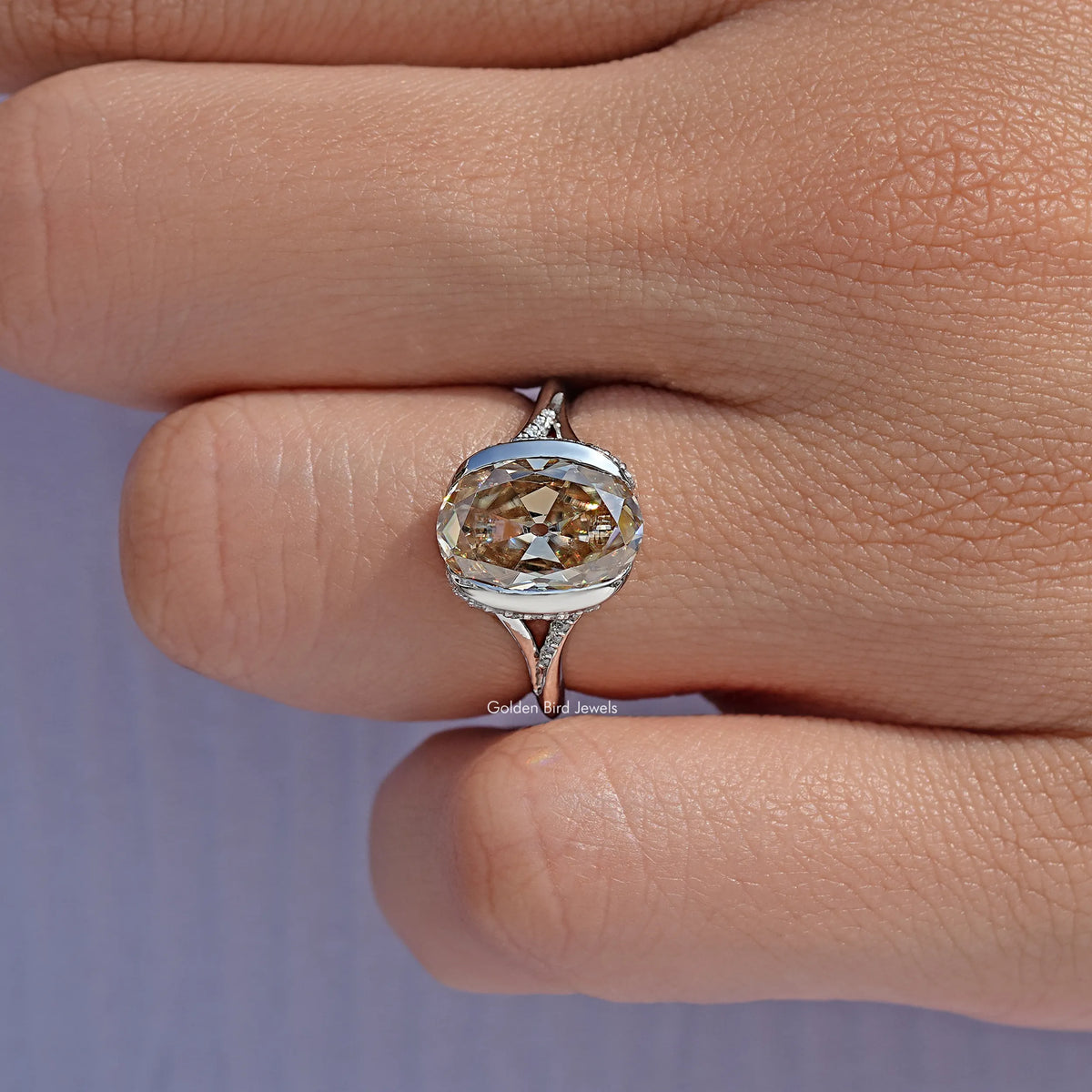 Silver engagement ring with oval-cut center stone and ornate split shank detail