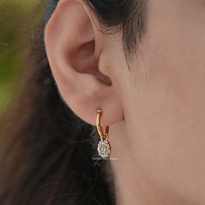 Gold-tone hoop dangle earring with oval-cut moissanite stone, side view