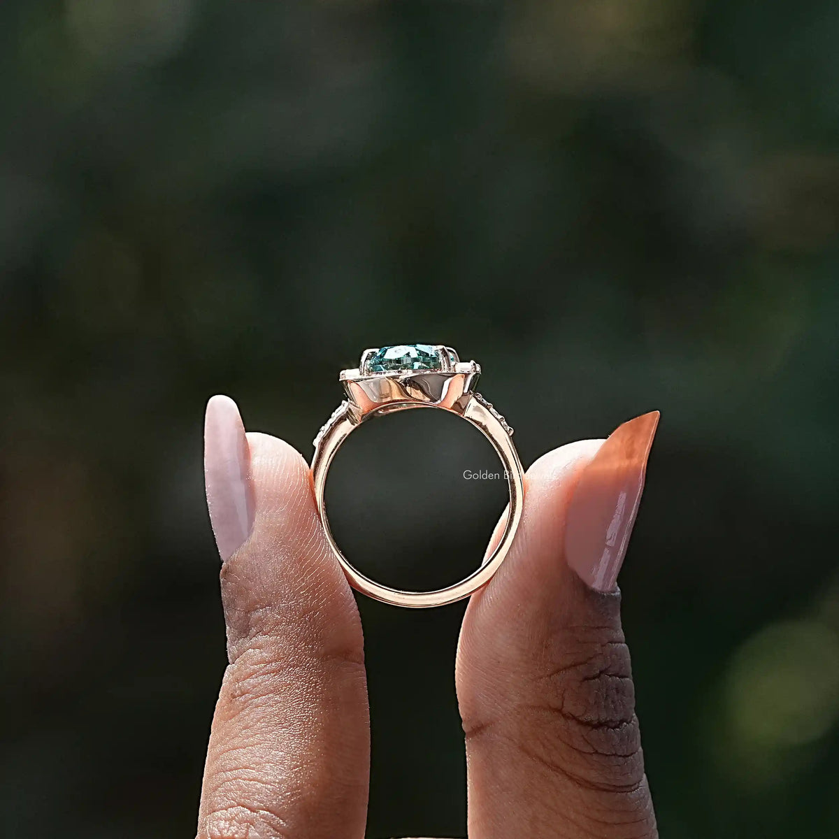 Back View of Oval Cut Moissanite Halo Ring In two fingers