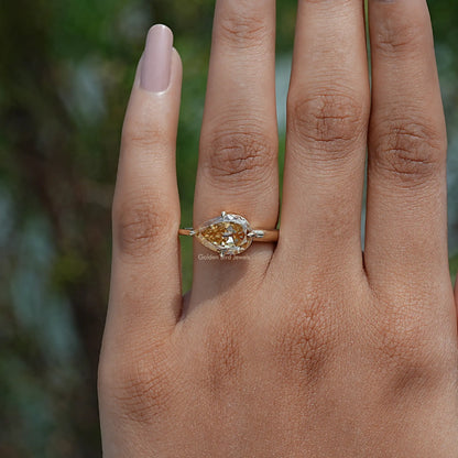 Close-Up View of  Pear Cut Moissanite Engagement Ring In Yellow Gold