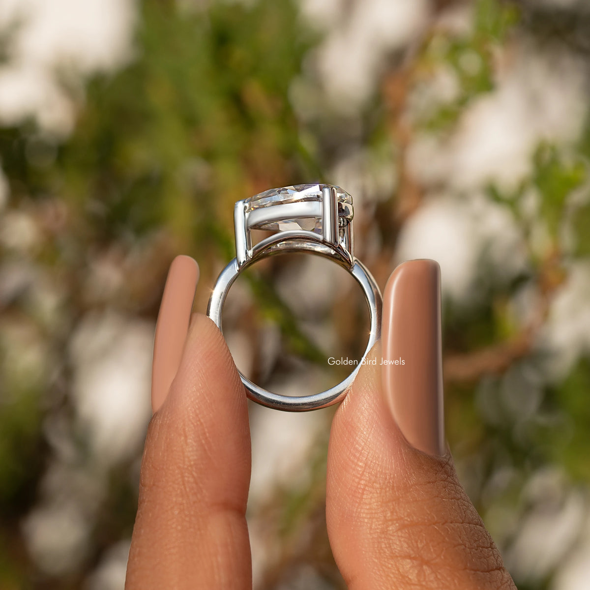 Sterling silver ring with pear-cut moissanite, open-back gallery view