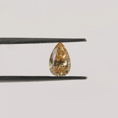 Twijer holding On the Old Mine Pear Cut Moissanite Stone