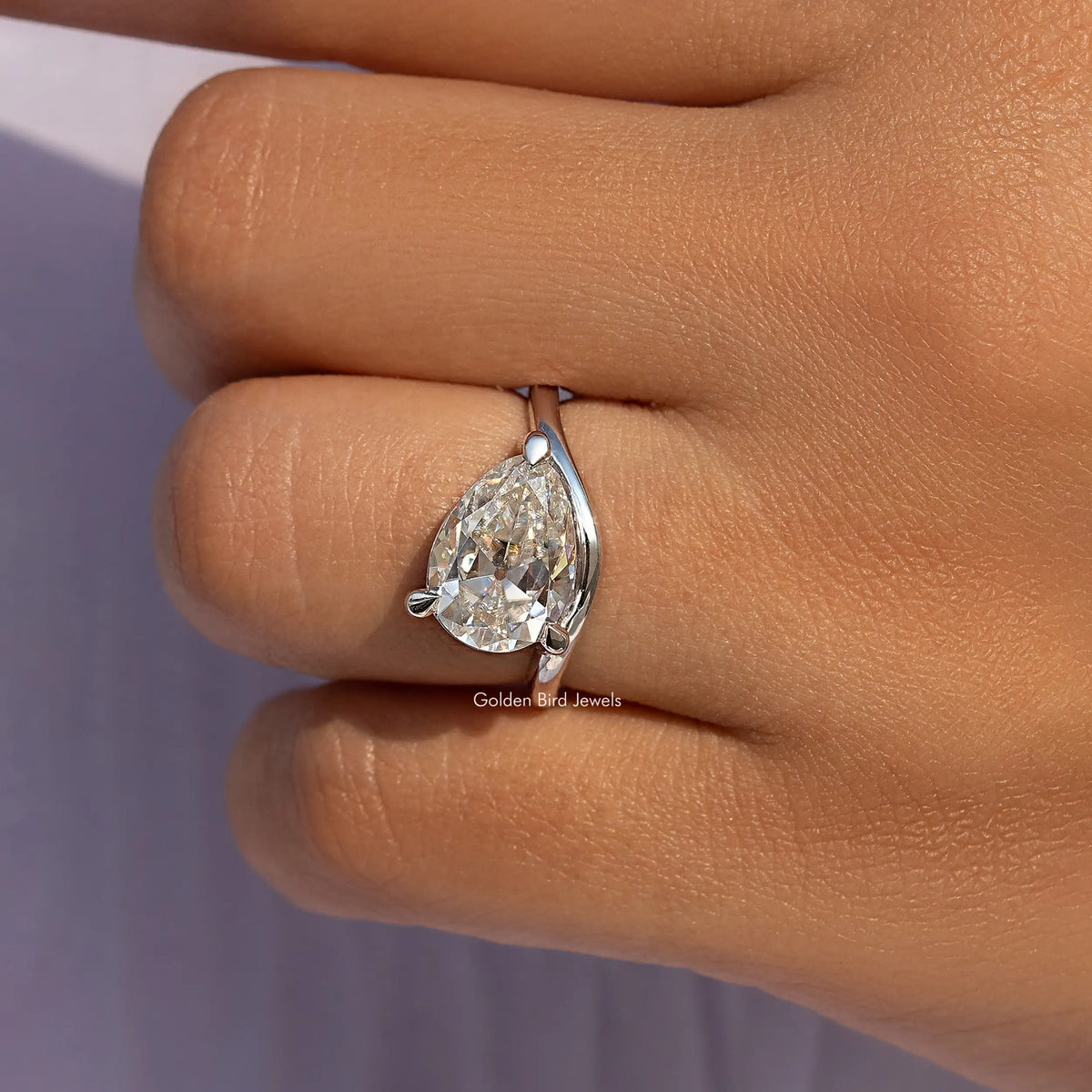 Pear-cut moissanite solitaire ring in sterling silver with claw-set center stone