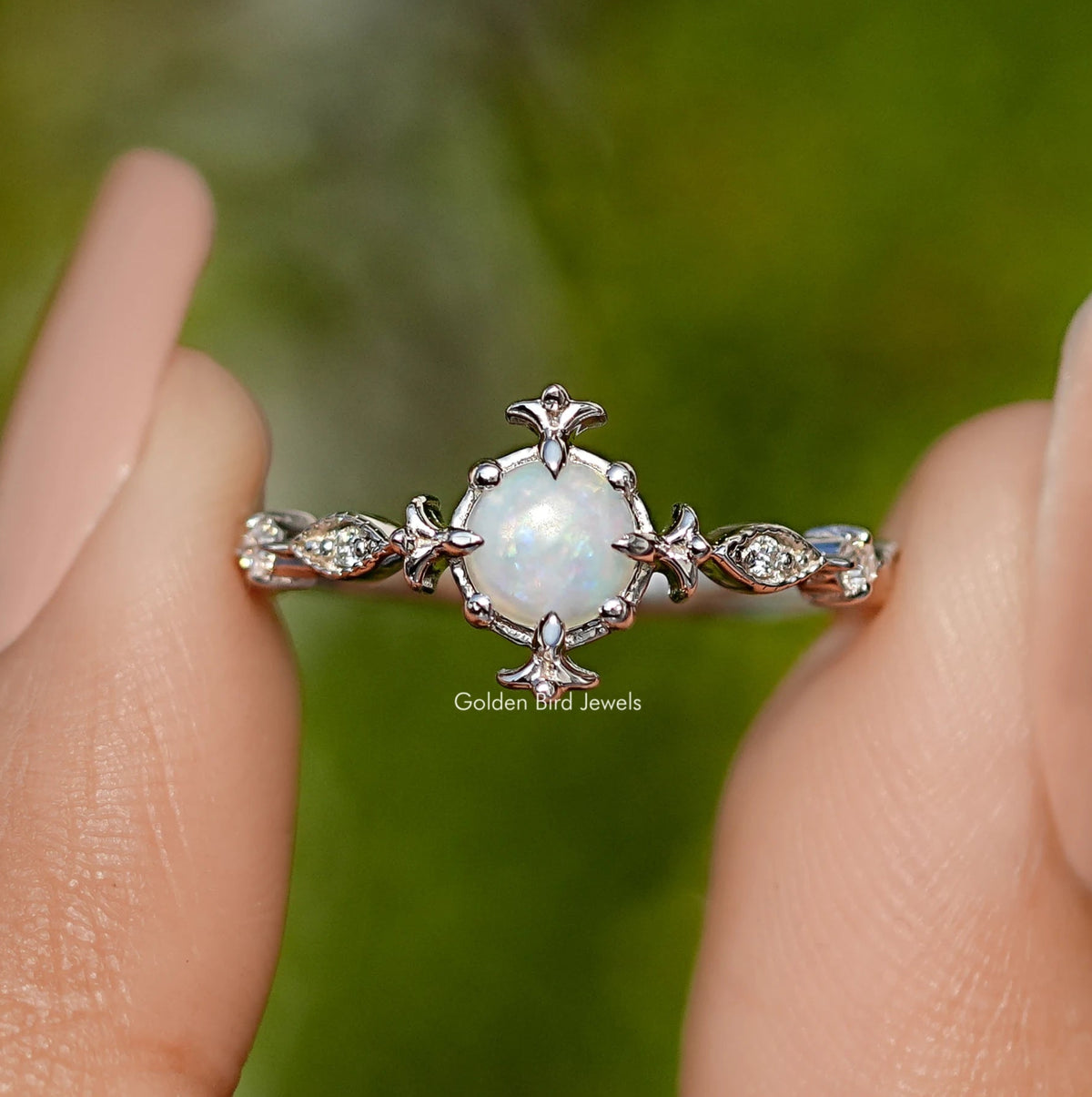 Opal engagement ring with round center stone and floral silver accents