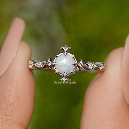 Opal engagement ring with round center stone and floral silver accents