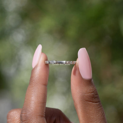 Silver baguette moissanite open-gap band between hands, bar-set stones