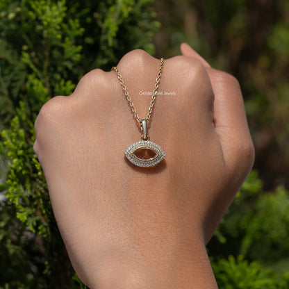 Moissanite open marquise cut pendant on a gold chain, seen on a hand