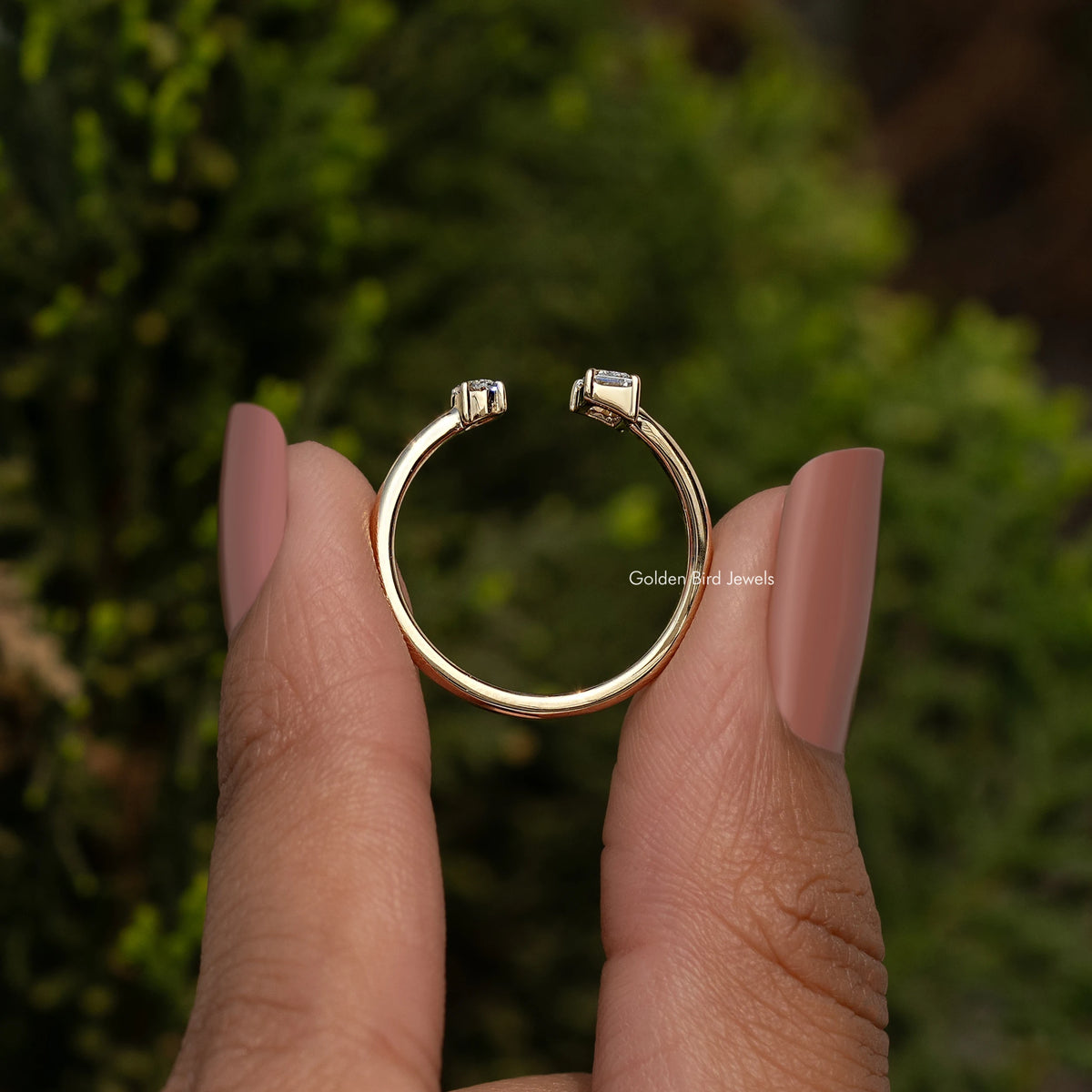 Gold open cuff ring with two raised bezel-set stones