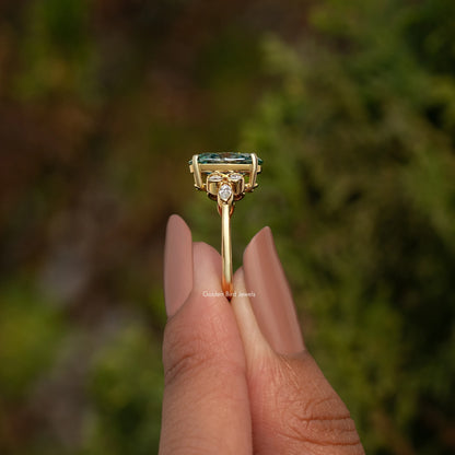 Side view of oval blue-green moissanite proposal ring with prong-set top