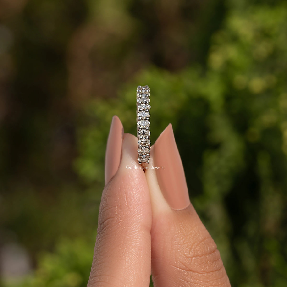 Oval-cut moissanite eternity band in 925 sterling silver, slim side view