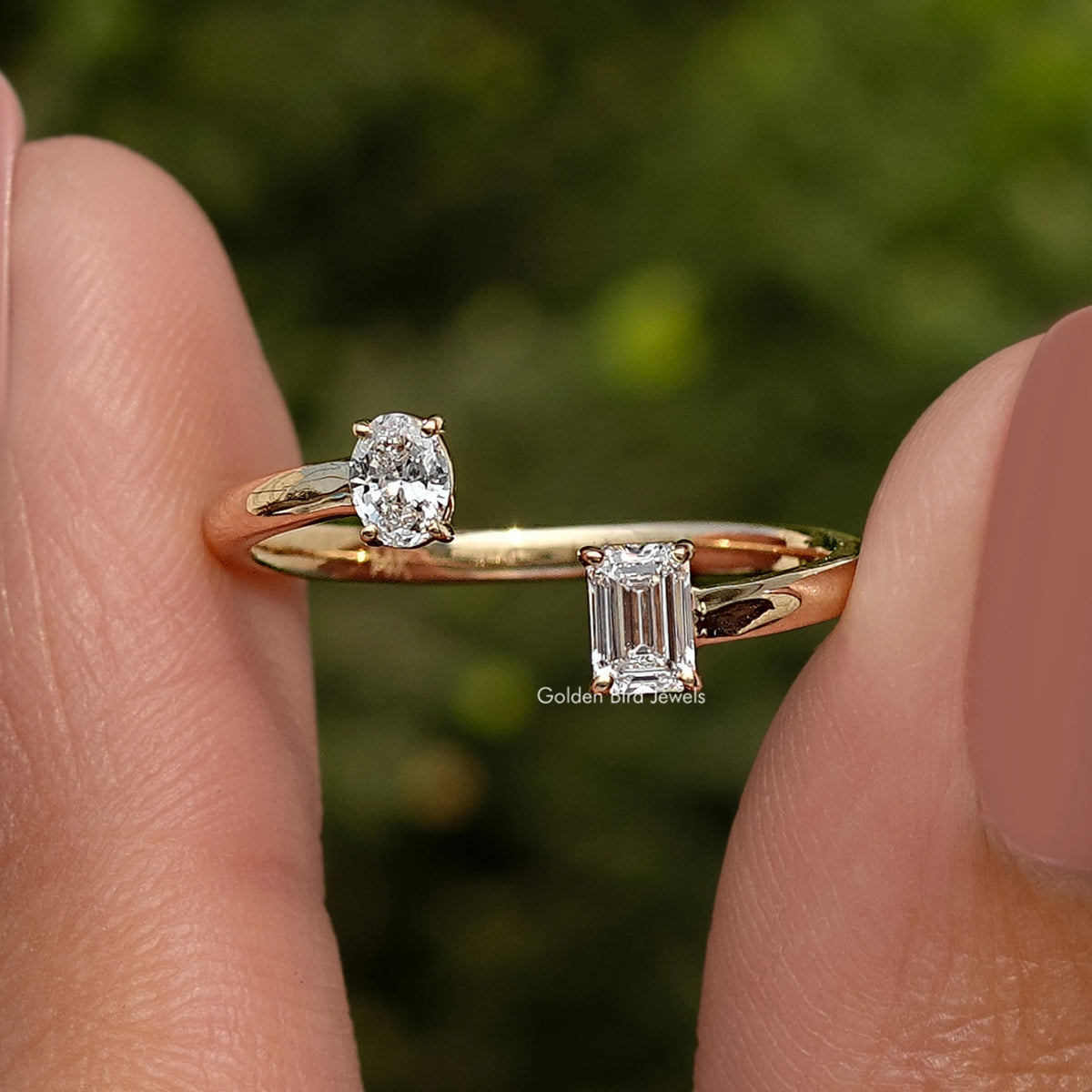 Side view of gold open cuff ring with round and emerald-cut lab diamonds