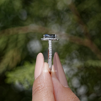 Side view of oval black moissanite halo ring with raised center setting