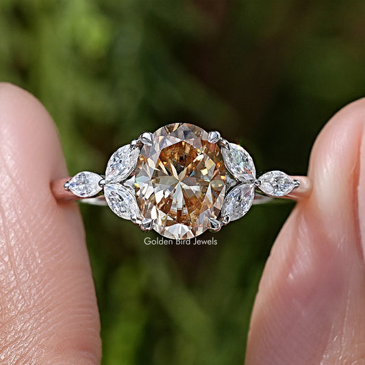 Oval moissanite center with four leaf side stones in sterling silver prong setting