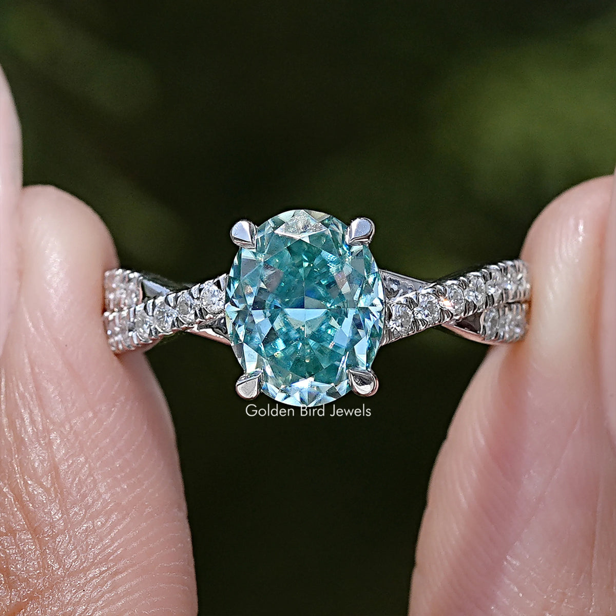 Sterling silver ring with large oval blue moissanite center and sparkling side stones