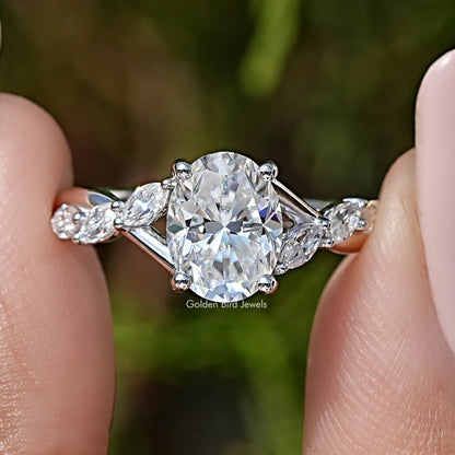 Oval moissanite solitaire engagement ring with floral halo and side stones, sterling silver