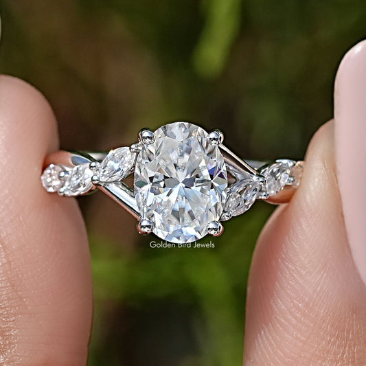 Oval moissanite solitaire engagement ring with floral halo and side stones, sterling silver