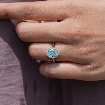 Oval moissanite halo solitaire ring in sterling silver, view from side