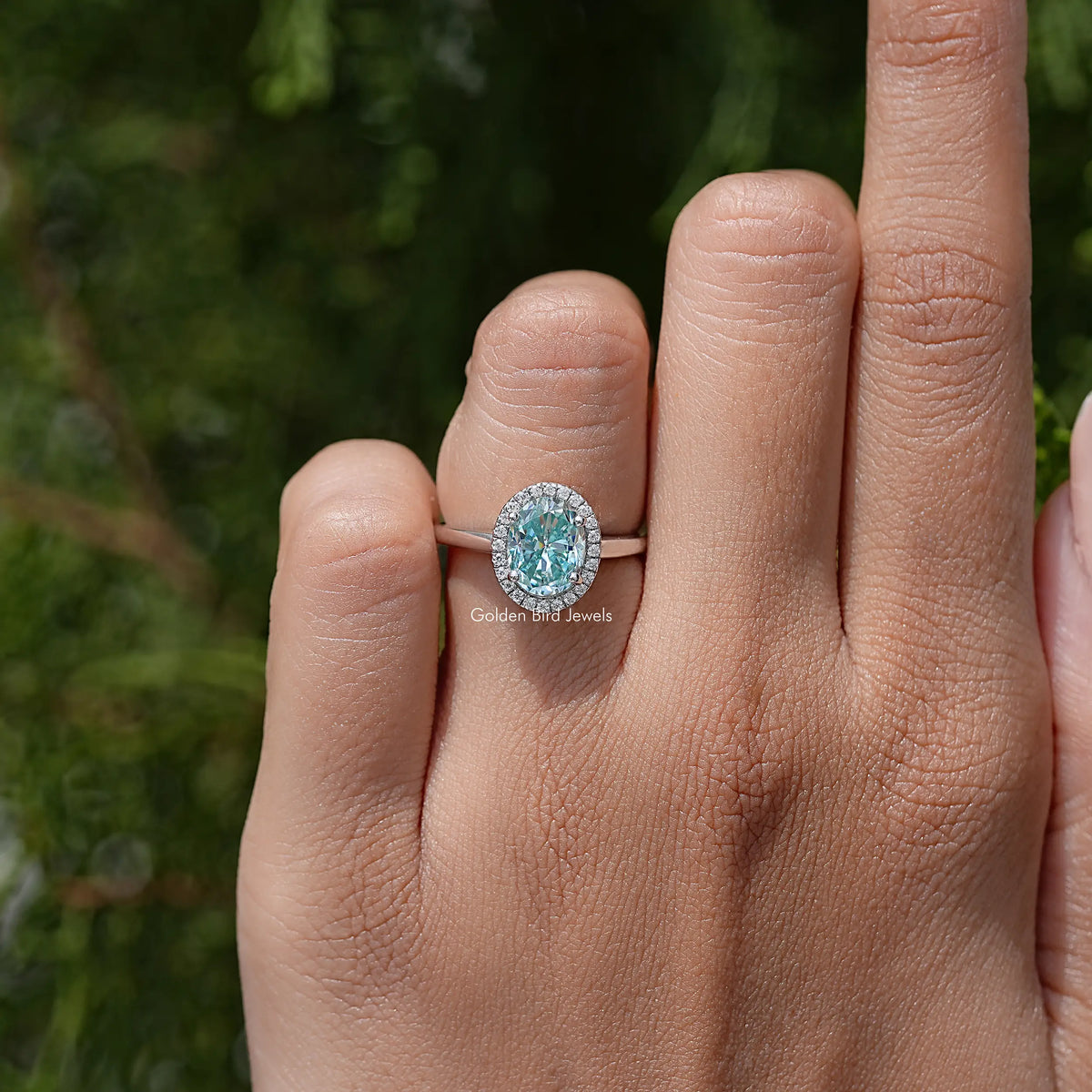 Sterling silver oval moissanite halo ring with prong-set center stone