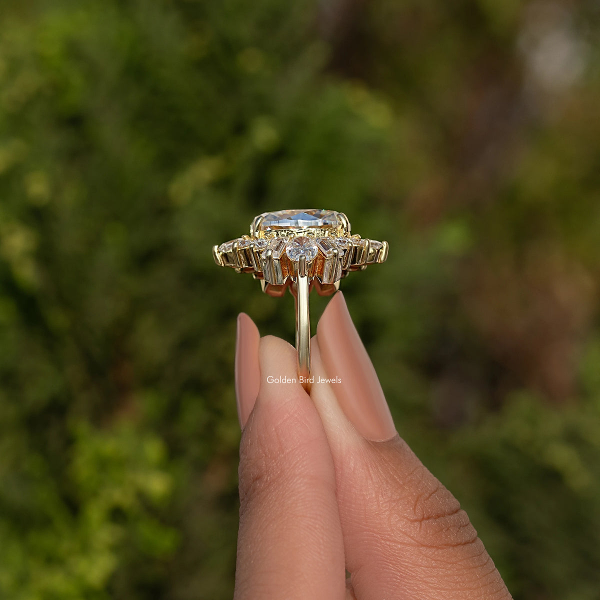 Oval moissanite halo ring with baguette-cut stones around the center, metal-tone