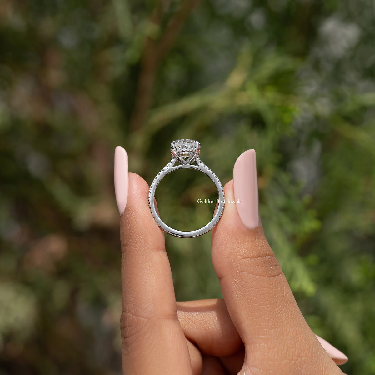 Oval-cut moissanite engagement ring with open band, silver setting and prongs