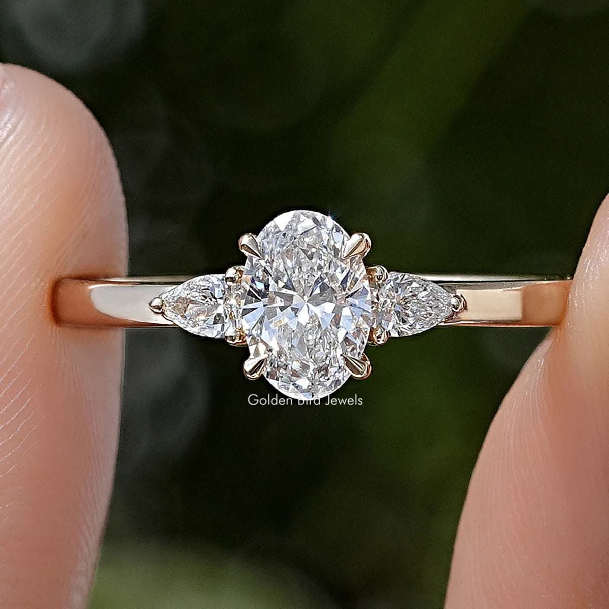 Three-stone lab-grown diamond anniversary ring, round center with side stones