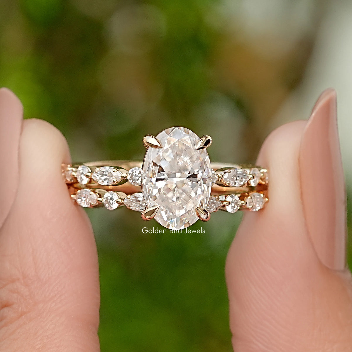 Oval-cut moissanite bridal ring set with pavé bands in yellow gold