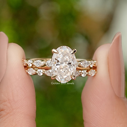 Oval-cut moissanite bridal ring set with pavé bands in yellow gold