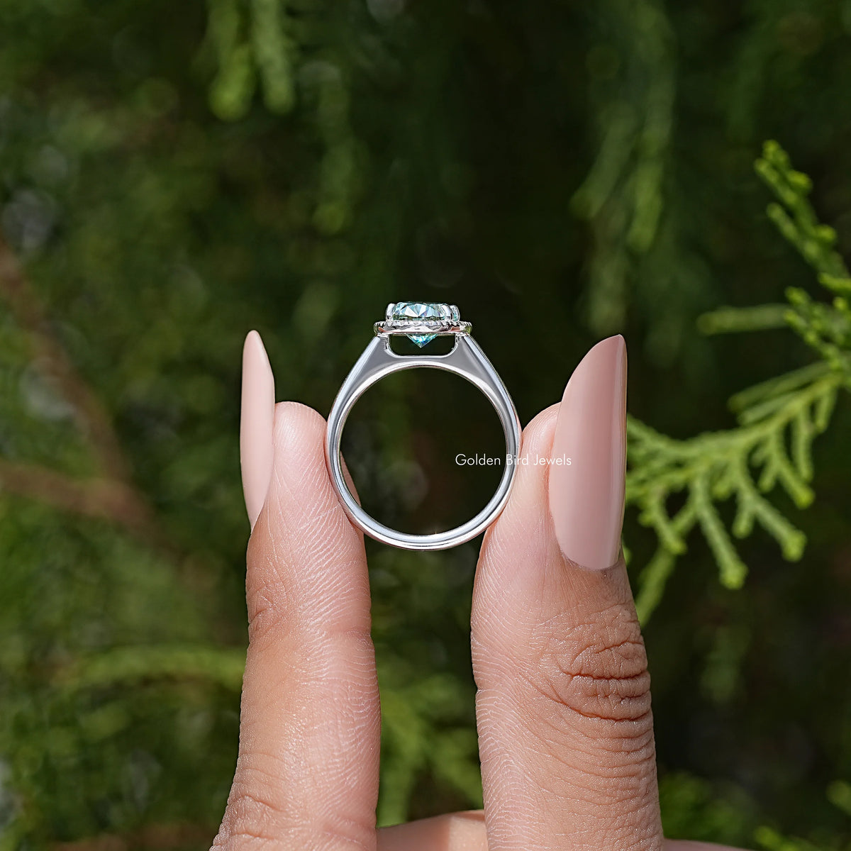 Sterling silver oval moissanite halo ring seen from the back with prongs