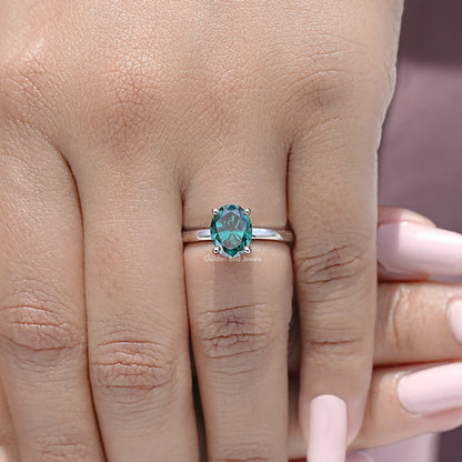 Oval-cut teal moissanite engagement ring in sterling silver, hidden halo band detail