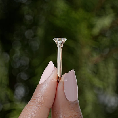 Three-stone lab-grown diamond ring top view, prong-set round center stone
