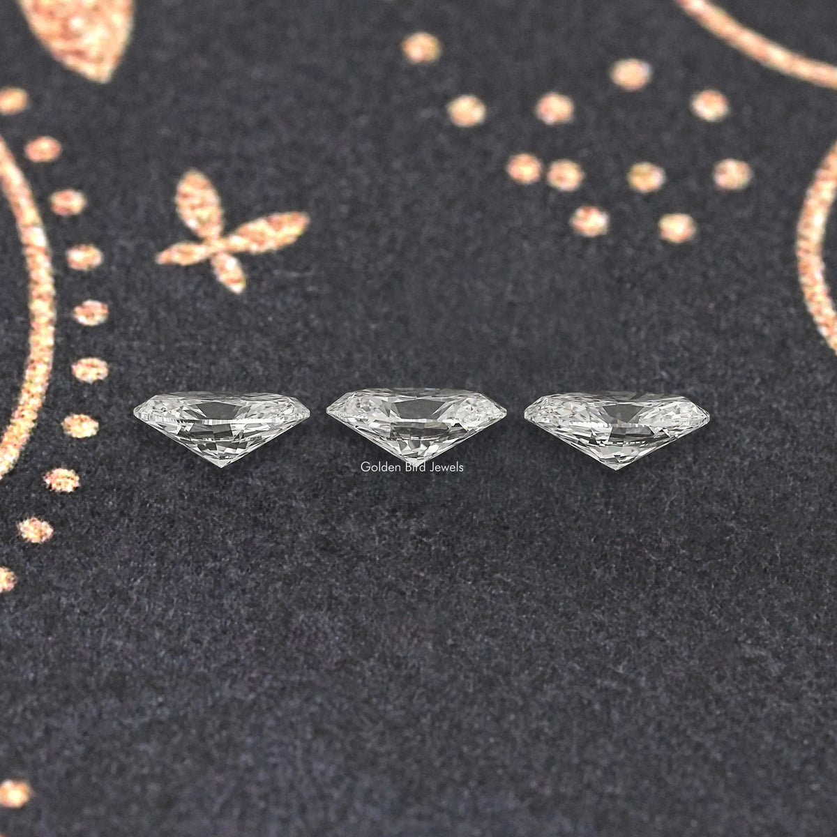 Set of three oval lab-grown diamonds on dark display
