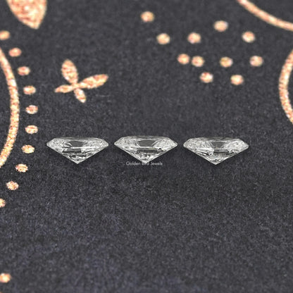 Set of three oval lab-grown diamonds on dark display