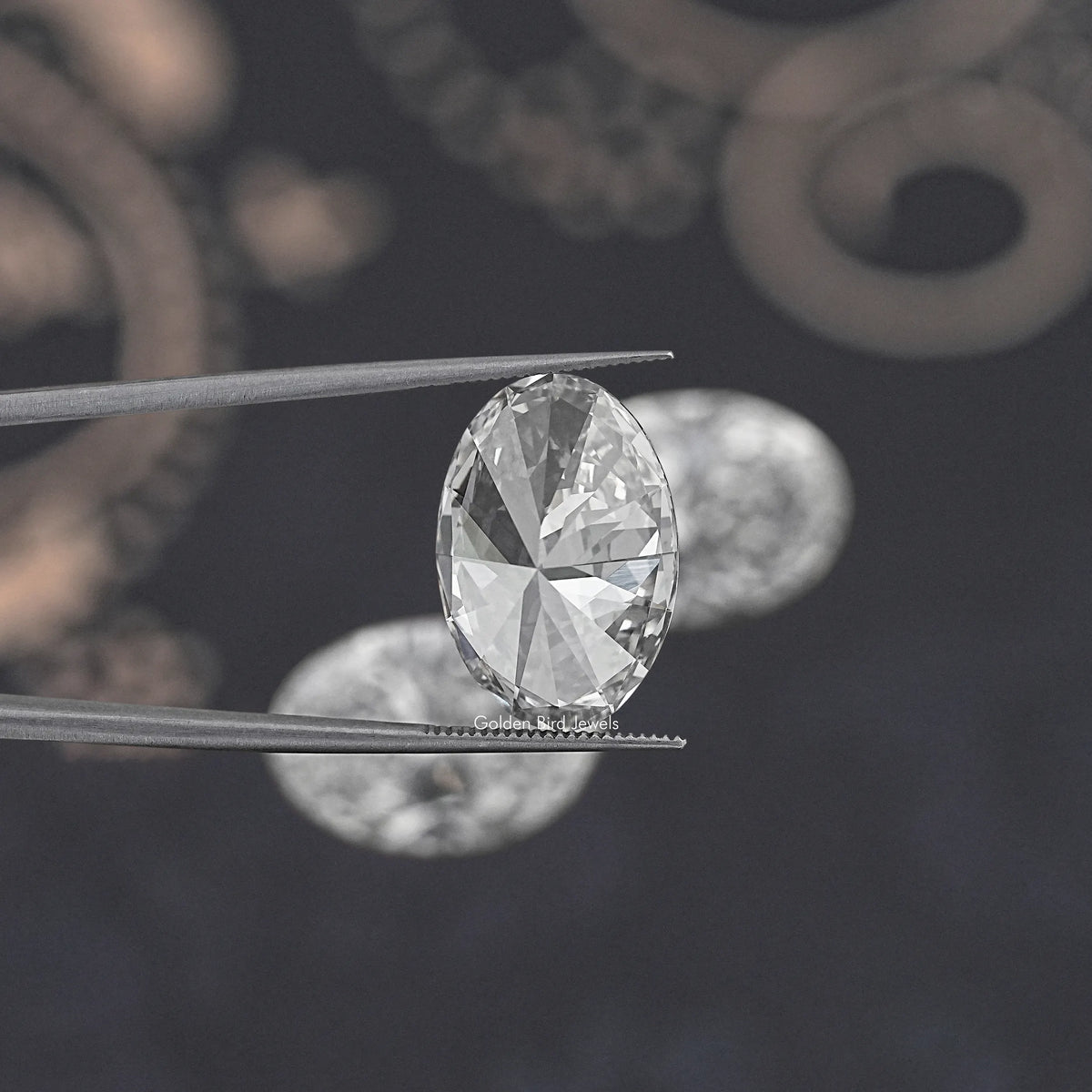 Oval-cut lab-grown diamond close-up held between metal tweezers