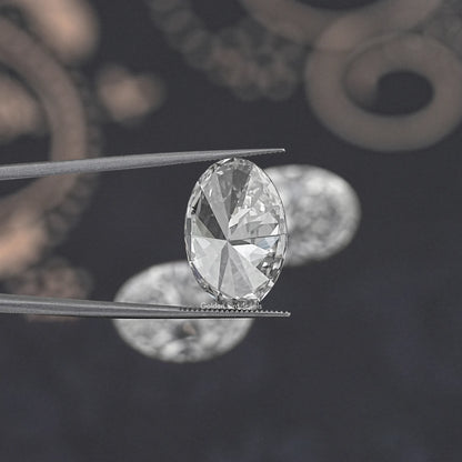Oval-cut lab-grown diamond close-up held between metal tweezers