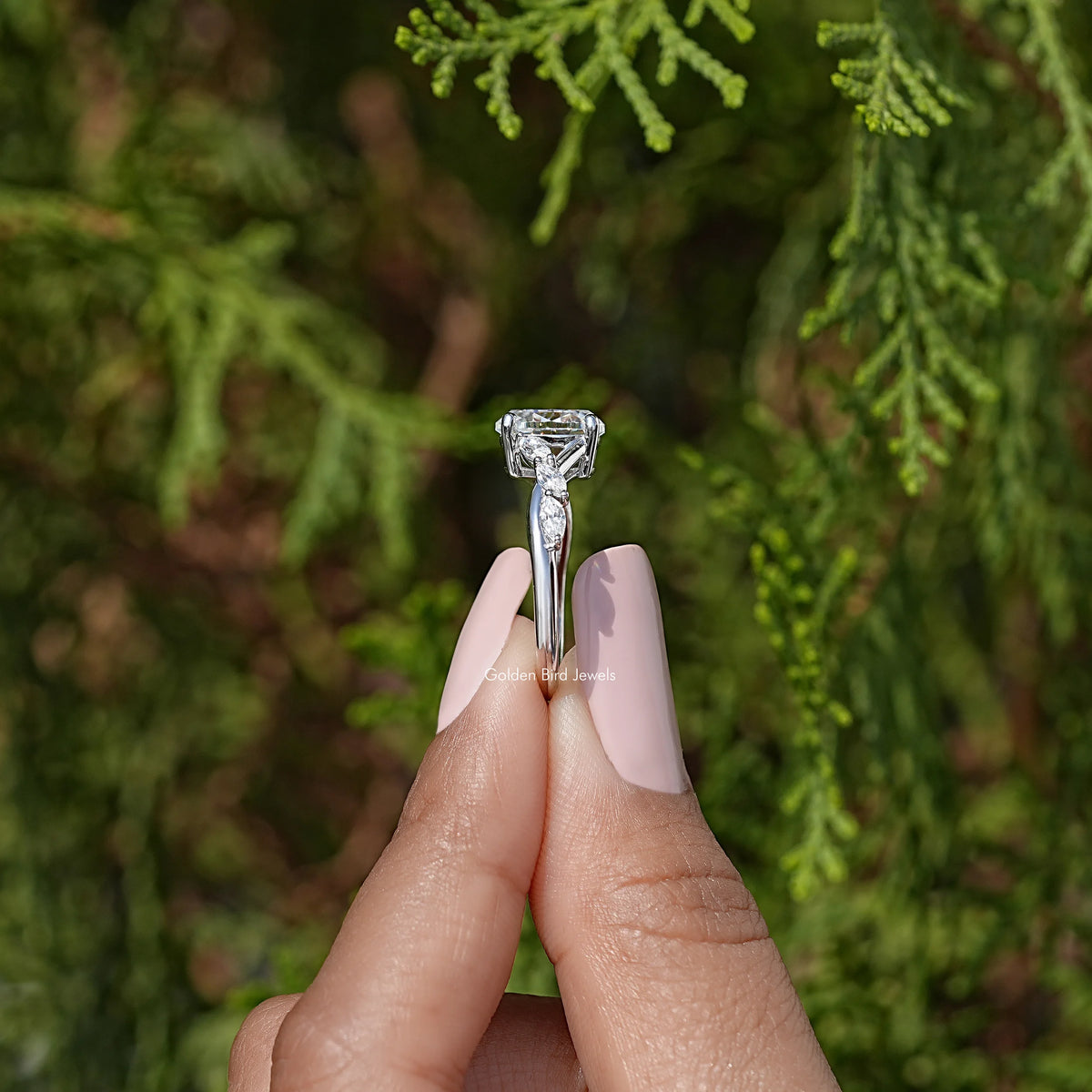 Top view of oval moissanite solitaire ring with square halo accents, sterling silver