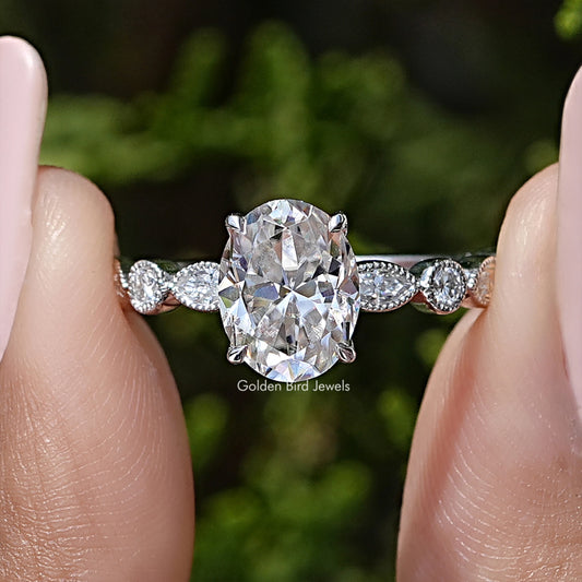 Sterling silver oval moissanite engagement ring with round halo and milgrain side stones