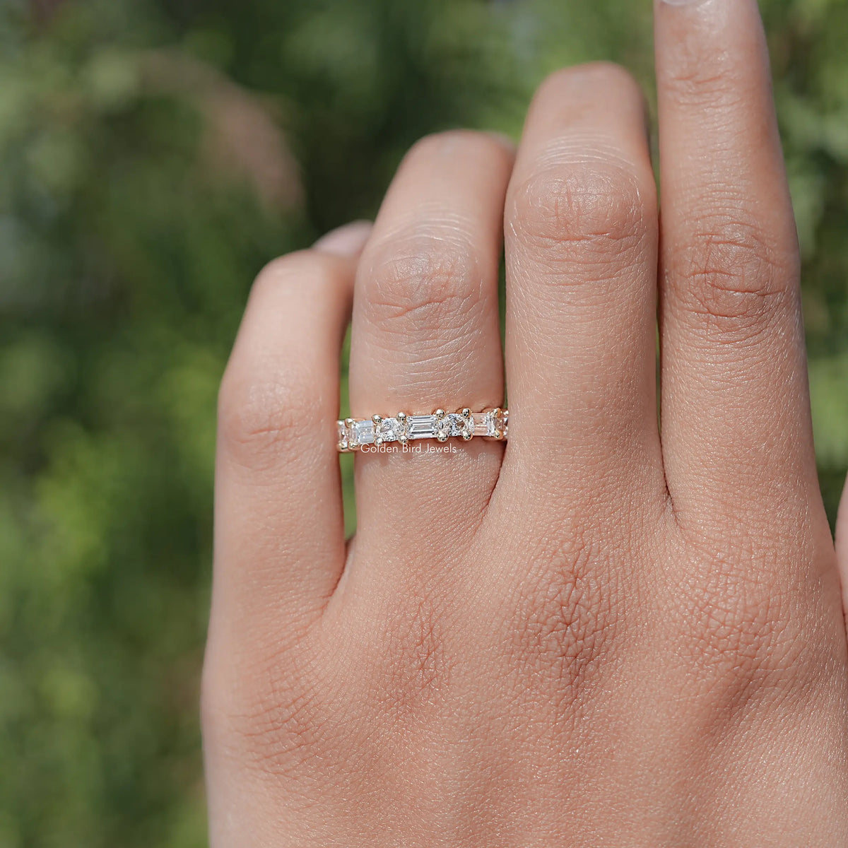 Lab diamond baguette band ring close-up on hand, row of rectangular stones
