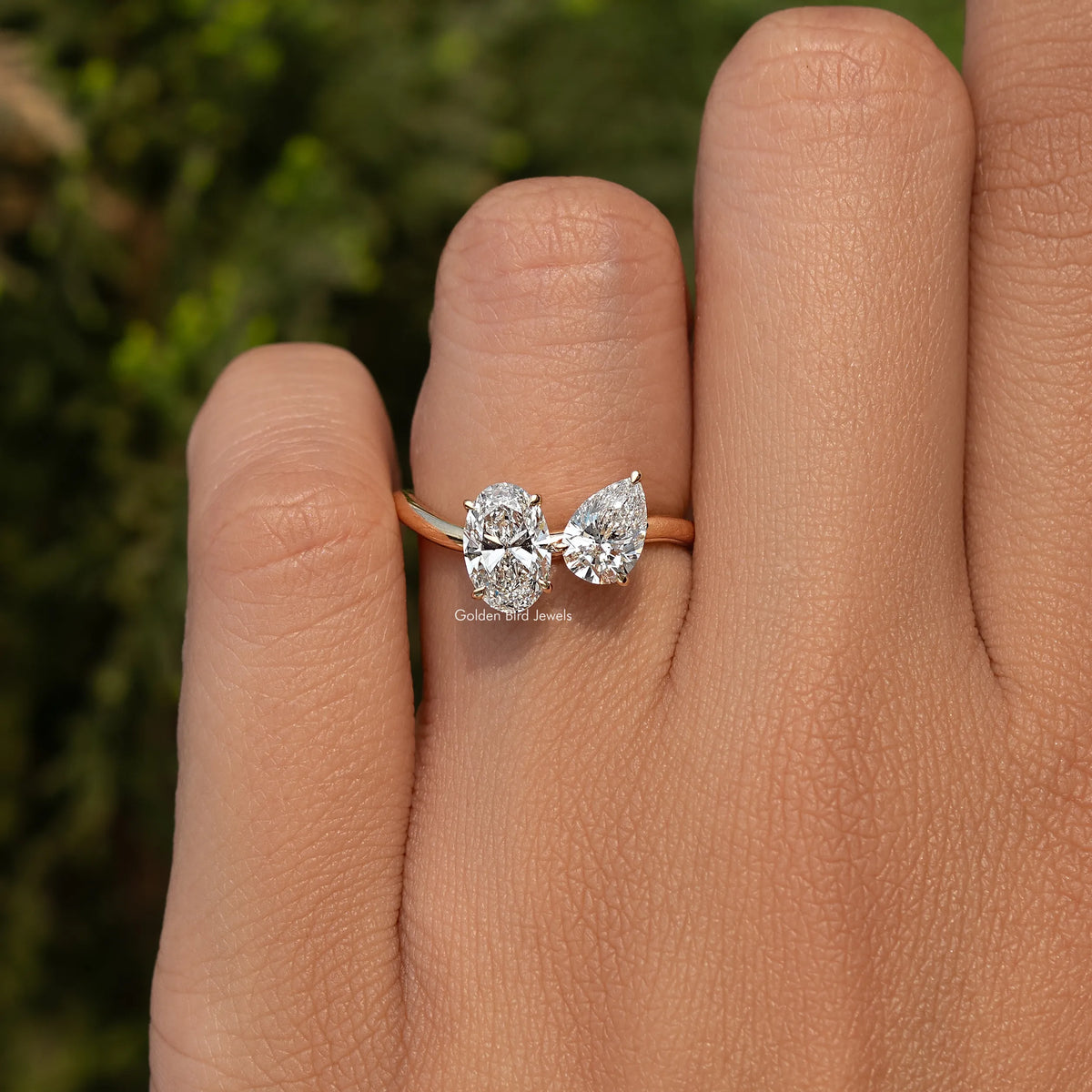 Gold toi et moi ring with oval and pear-cut lab diamonds, two-stone split shank