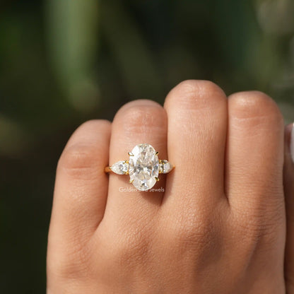 Close-Up View of Oval And Pear Cut Moissanite Ring In Yellow Gold