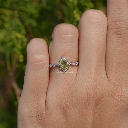 Peridot green oval-cut gemstone accent ring with floral details