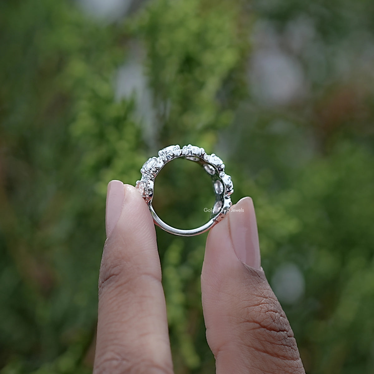 Back view of Oval Cut Diamond Seven Stone Band Held in Finger