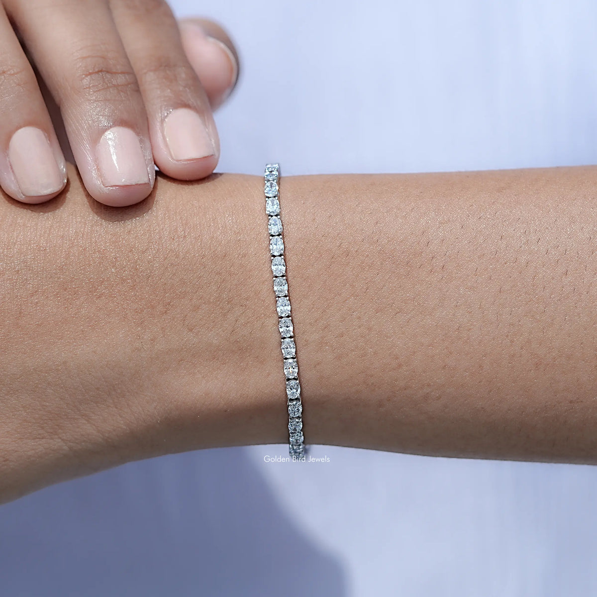 In hand Showing View Of Oval Cut Lab Tennis Bracelet
