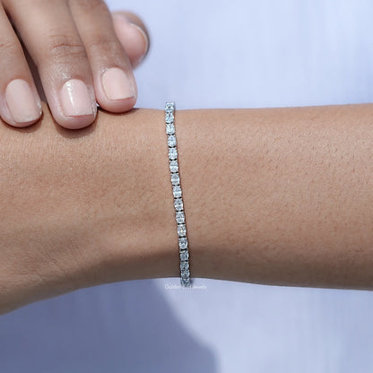 In hand Showing View Of Oval Cut Lab Tennis Bracelet
