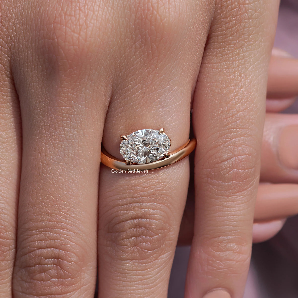 Oval solitaire bridal ring with rose-gold curved band and oval center diamond