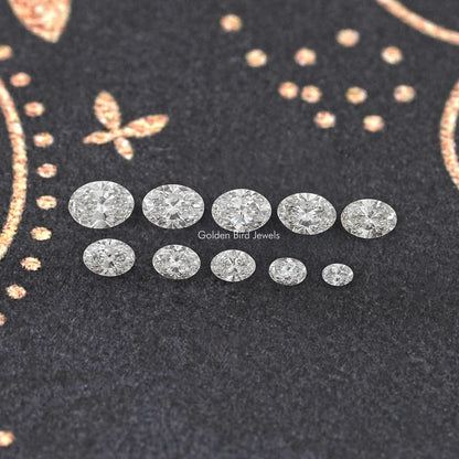 Oval-cut lab-grown diamond assortment arranged in two rows on dark display