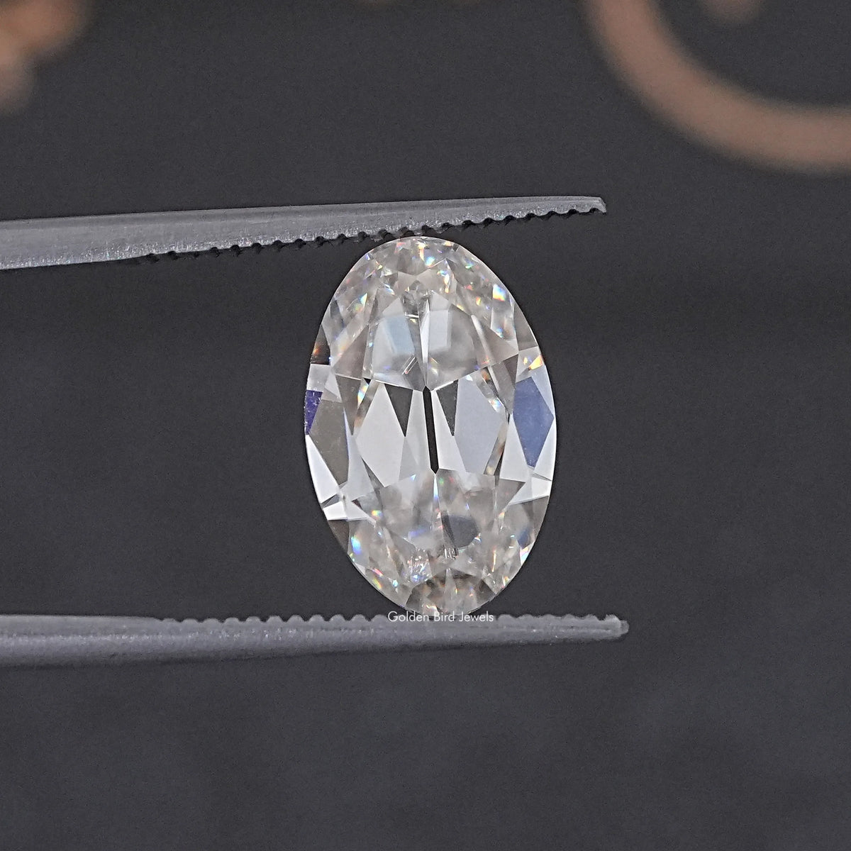 In Tweezer View Of Old Mine Oval Cut Loose Moissanite Stone