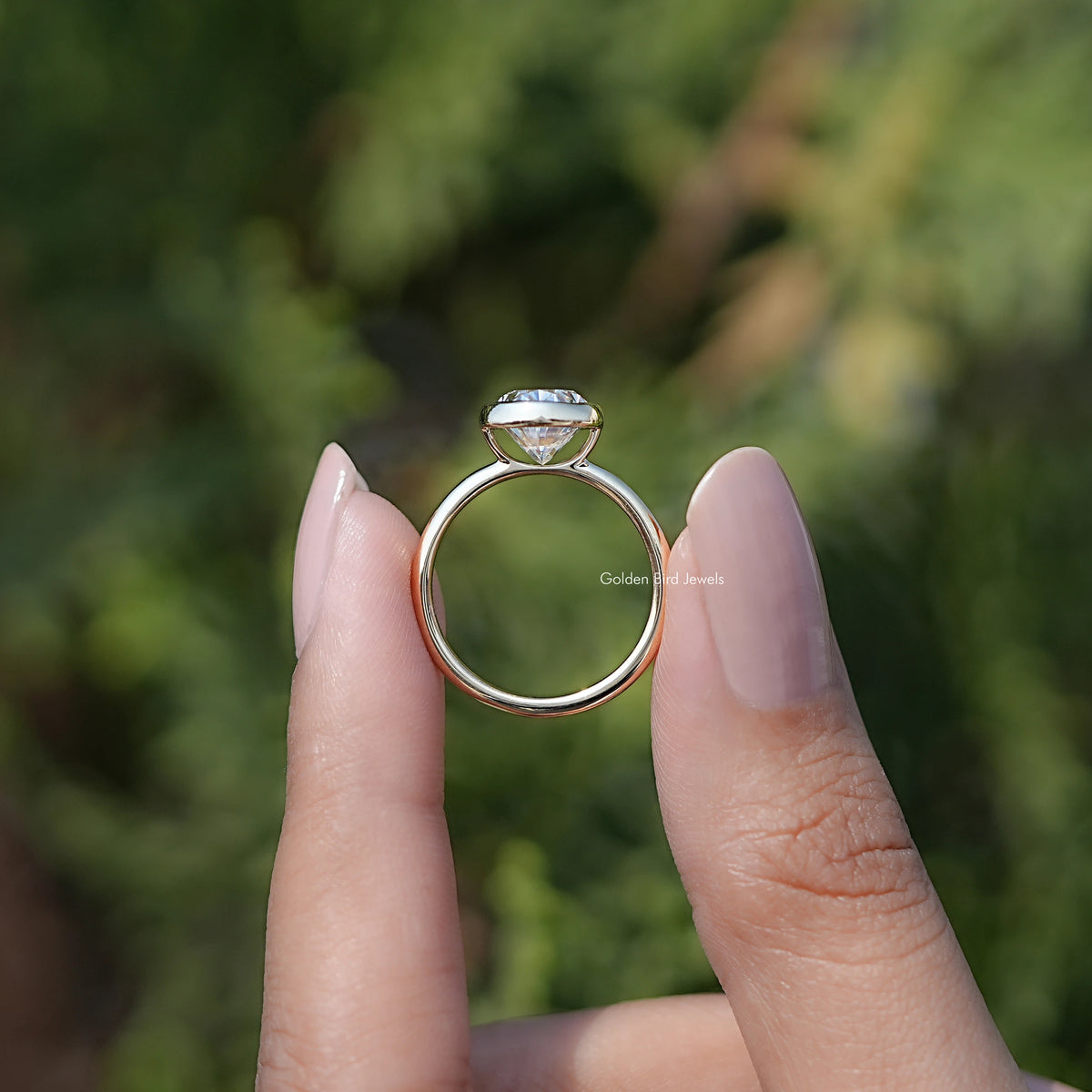 Back view of Bezel Set Oval Moissanite Engagement Ring in secure setting 
