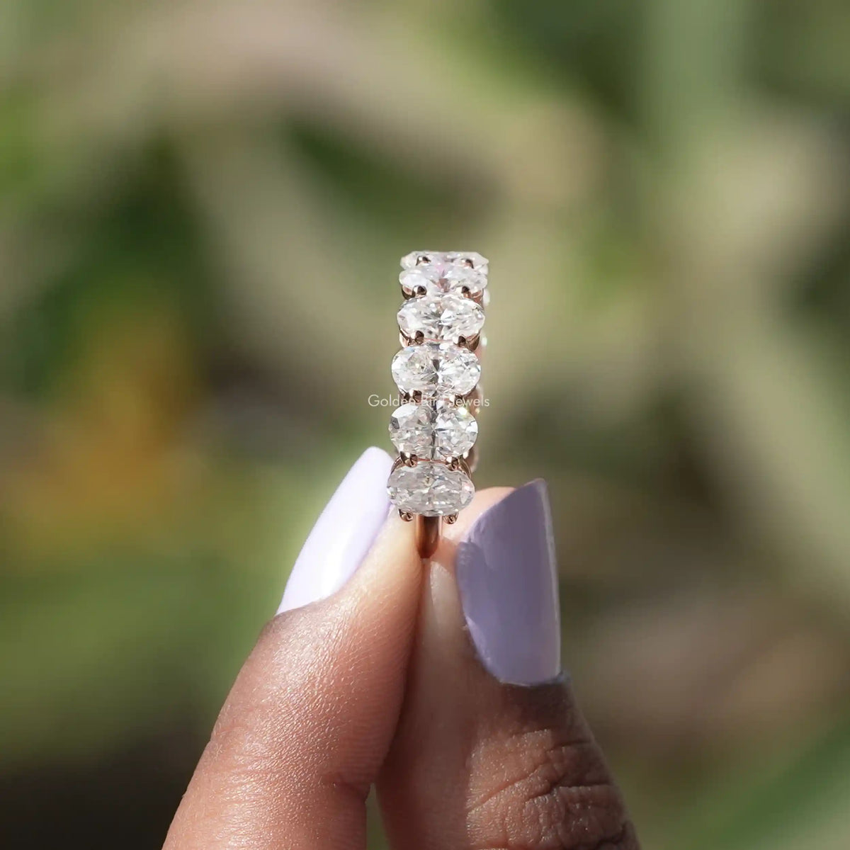Oval-cut moissanite 3/4 eternity band close-up with stacked prong-set stones